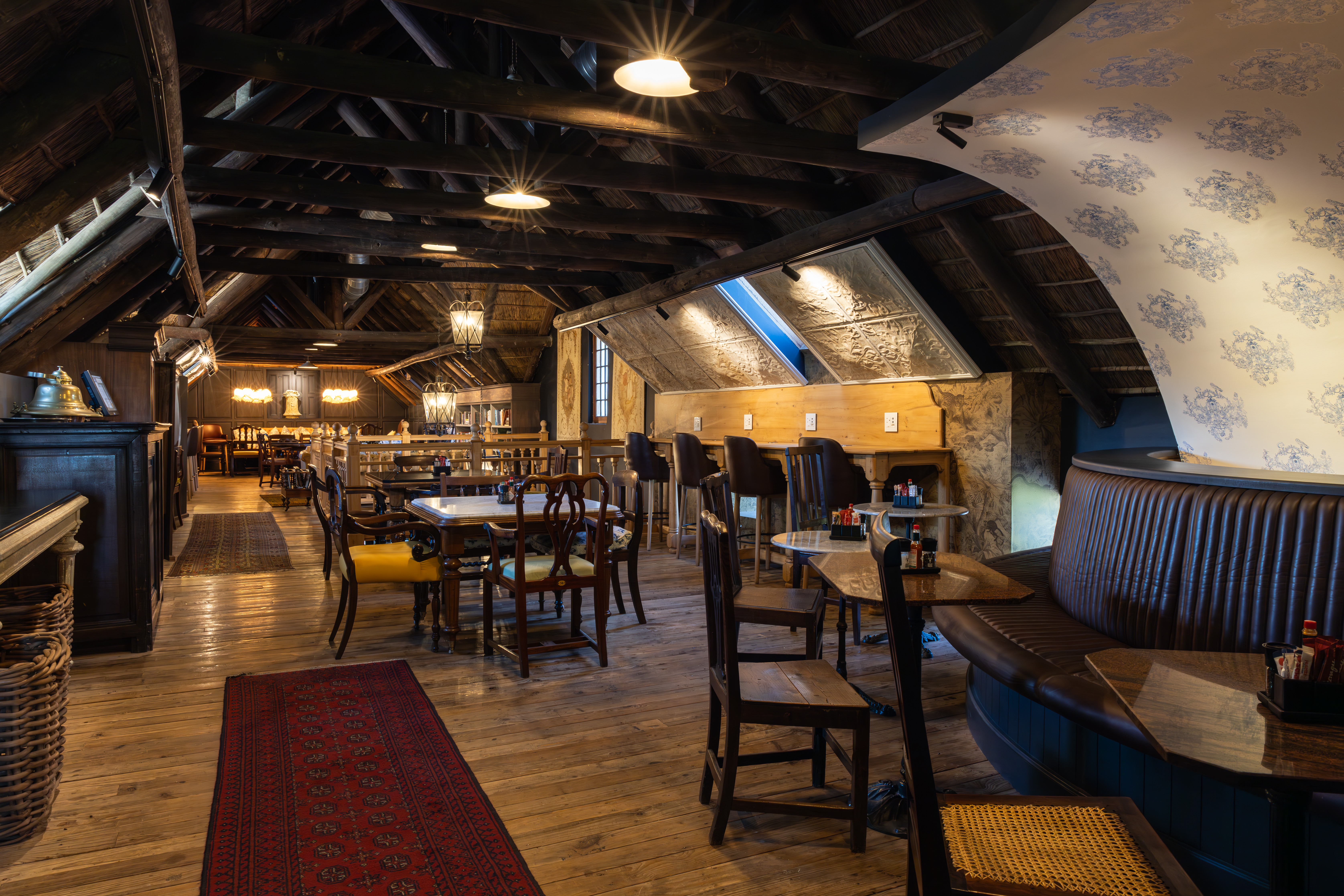 Interior tasting room at Lanzerac in Stellenbosch featuring wooden beams, tables and seating inside the historic Cape Winelands estate.