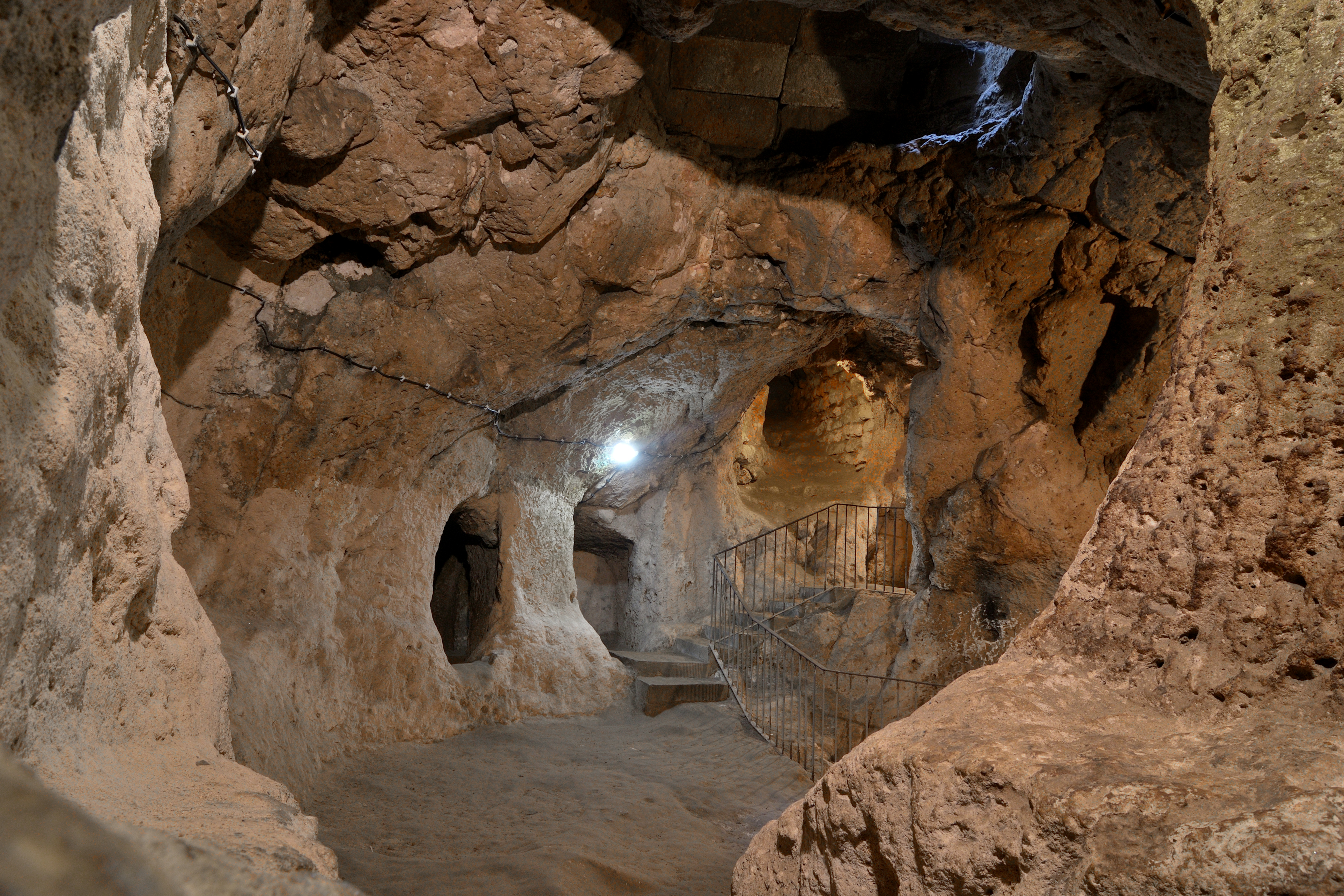 Underground rock chambers and stairway inside Derinkuyu Underground City in Cappadocia, Turkey.