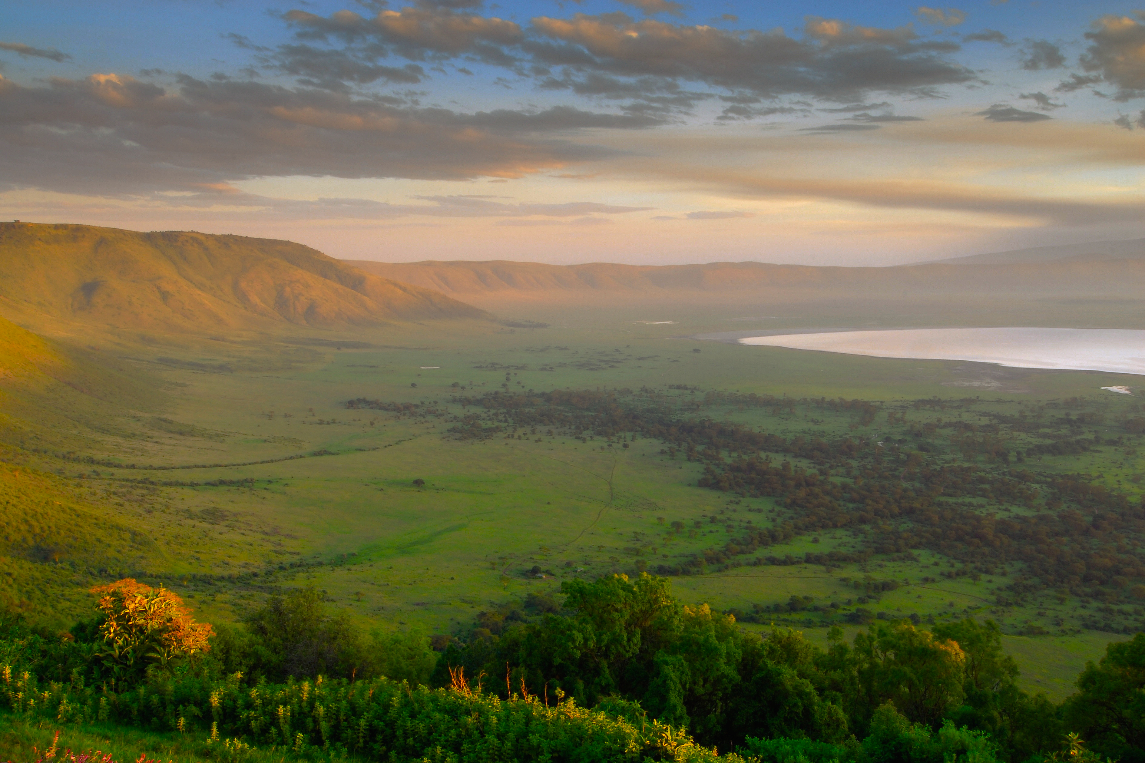 Sunrise view across the Ngorongoro Crater from the western rim, overlooking the vast caldera and crater floor in Tanzania.