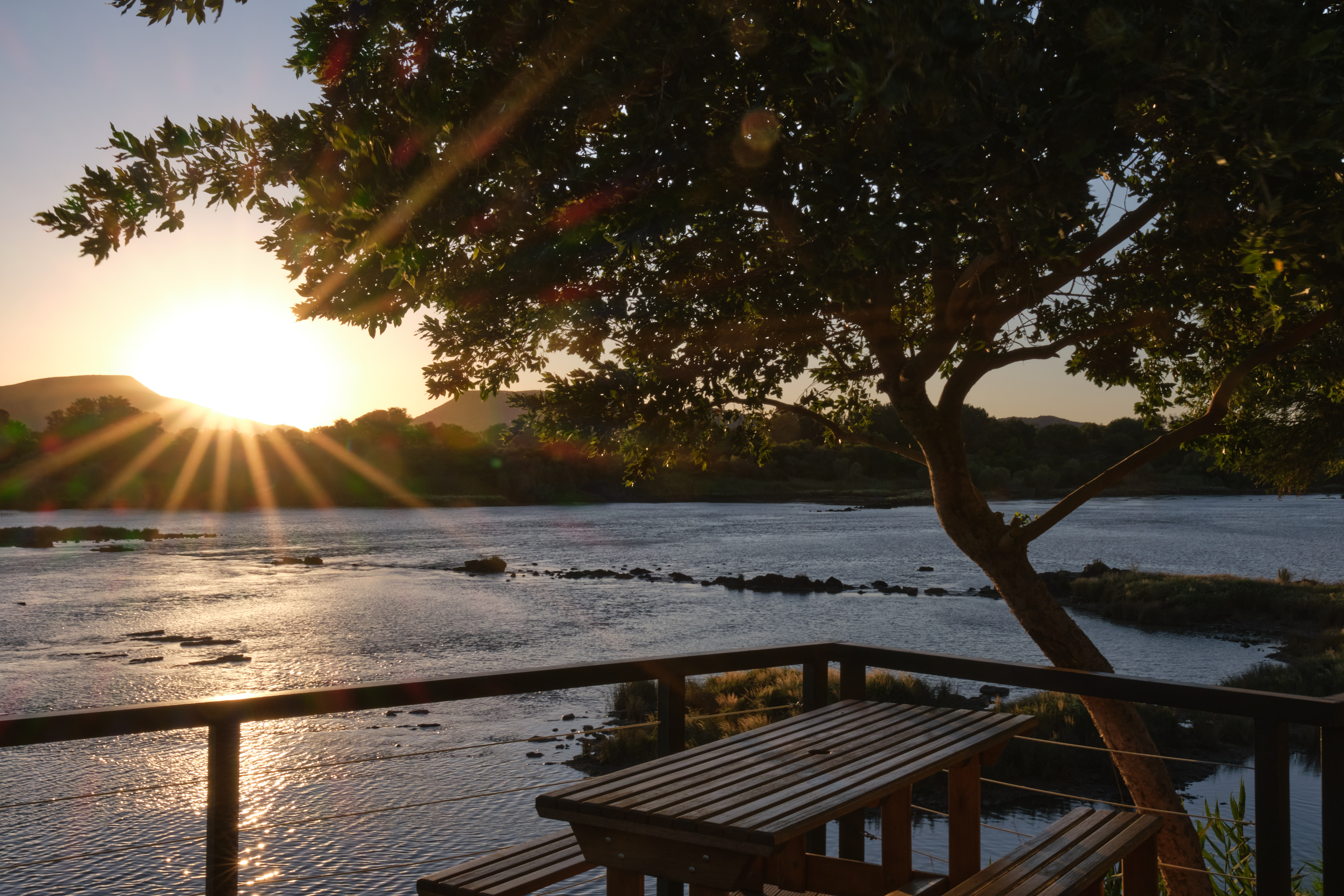 Sunset over the Orange River seen from the deck at Waschbank River Lodge near Gariep Dam, South Africa.