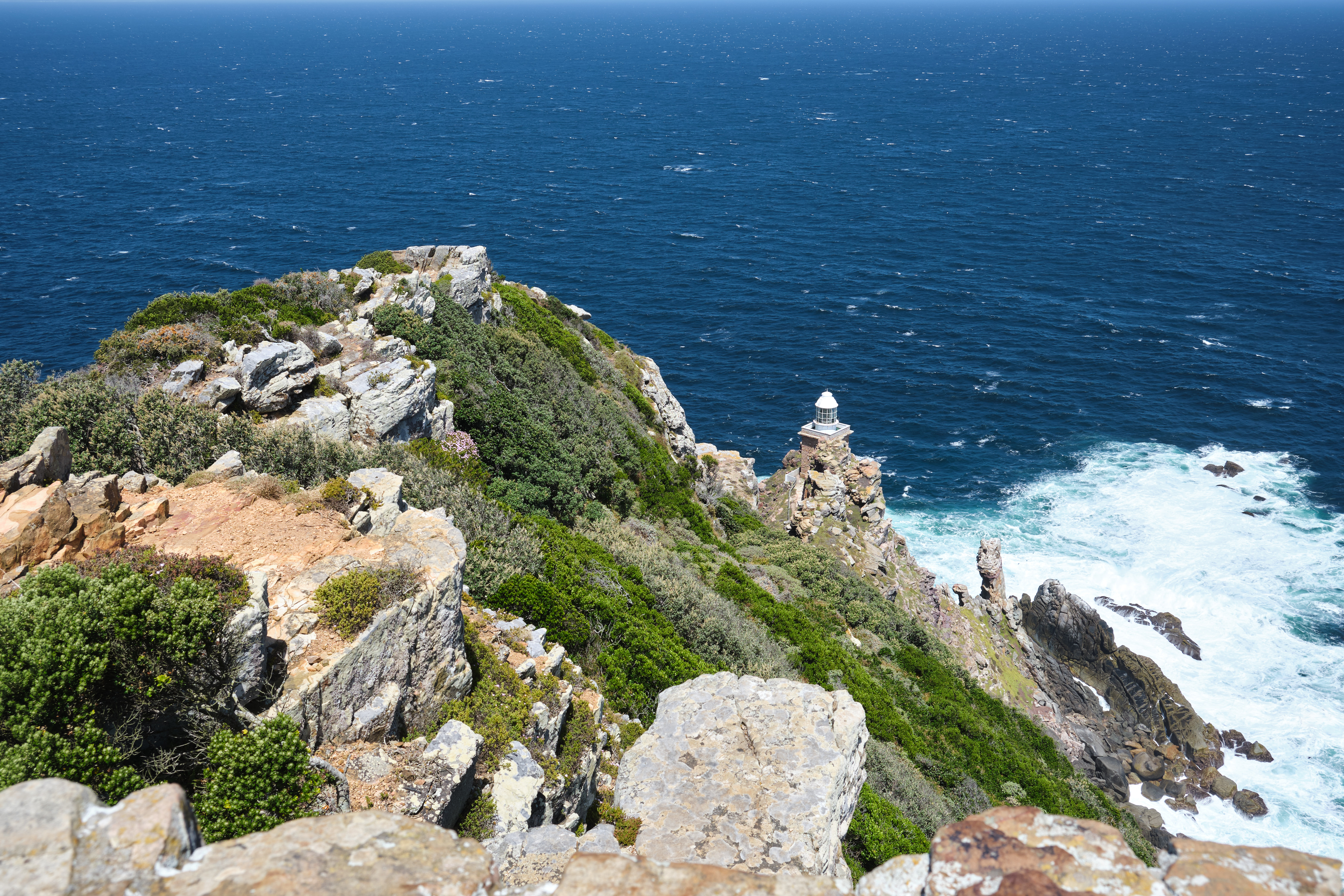Cape Point Lighthouse perched on a rocky cliff above the Atlantic Ocean at Cape Point in Table Mountain National Park, Cape Peninsula, South Africa.