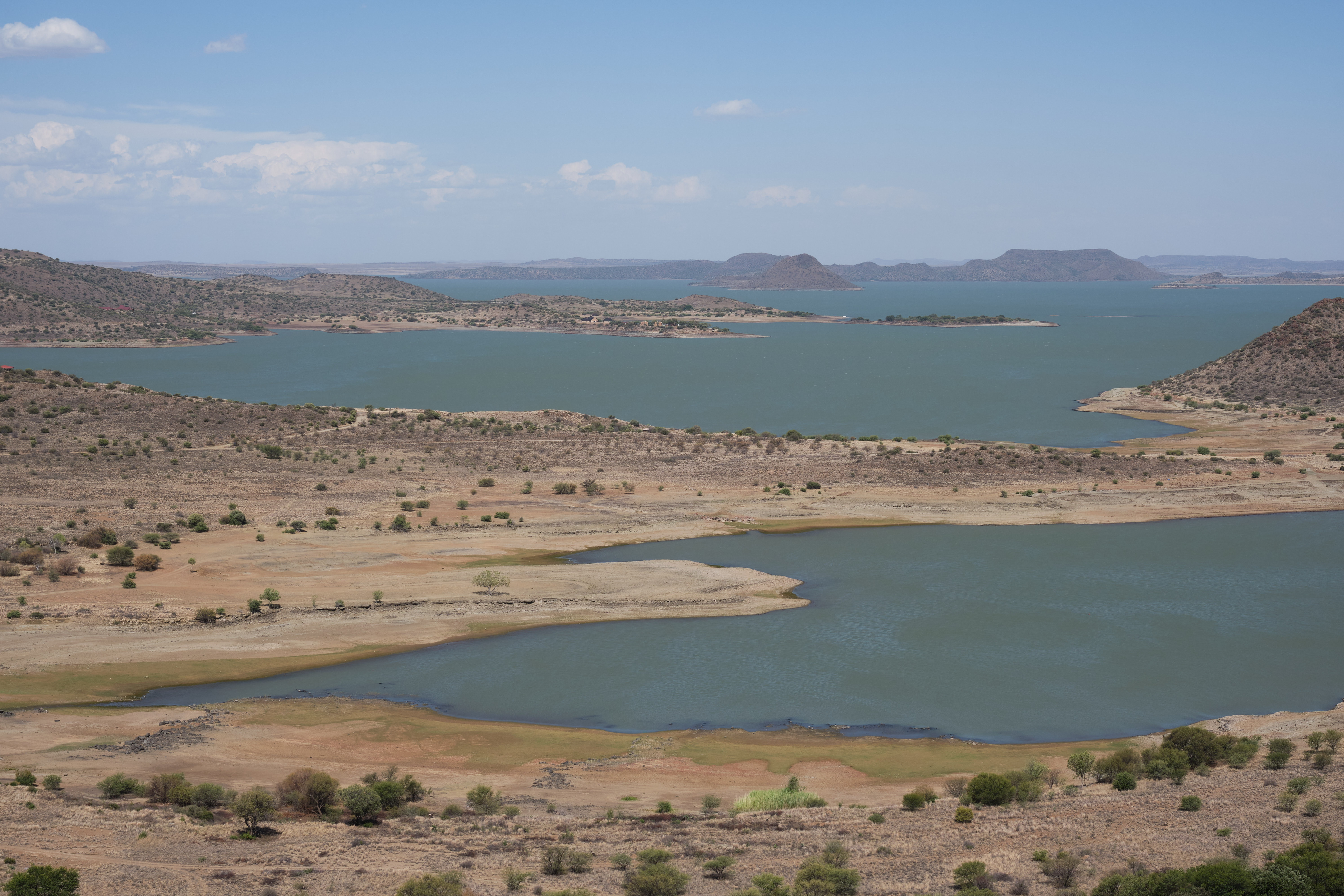 Wide view of Gariep Dam reservoir with islands, bays and surrounding Karoo hills in South Africa.