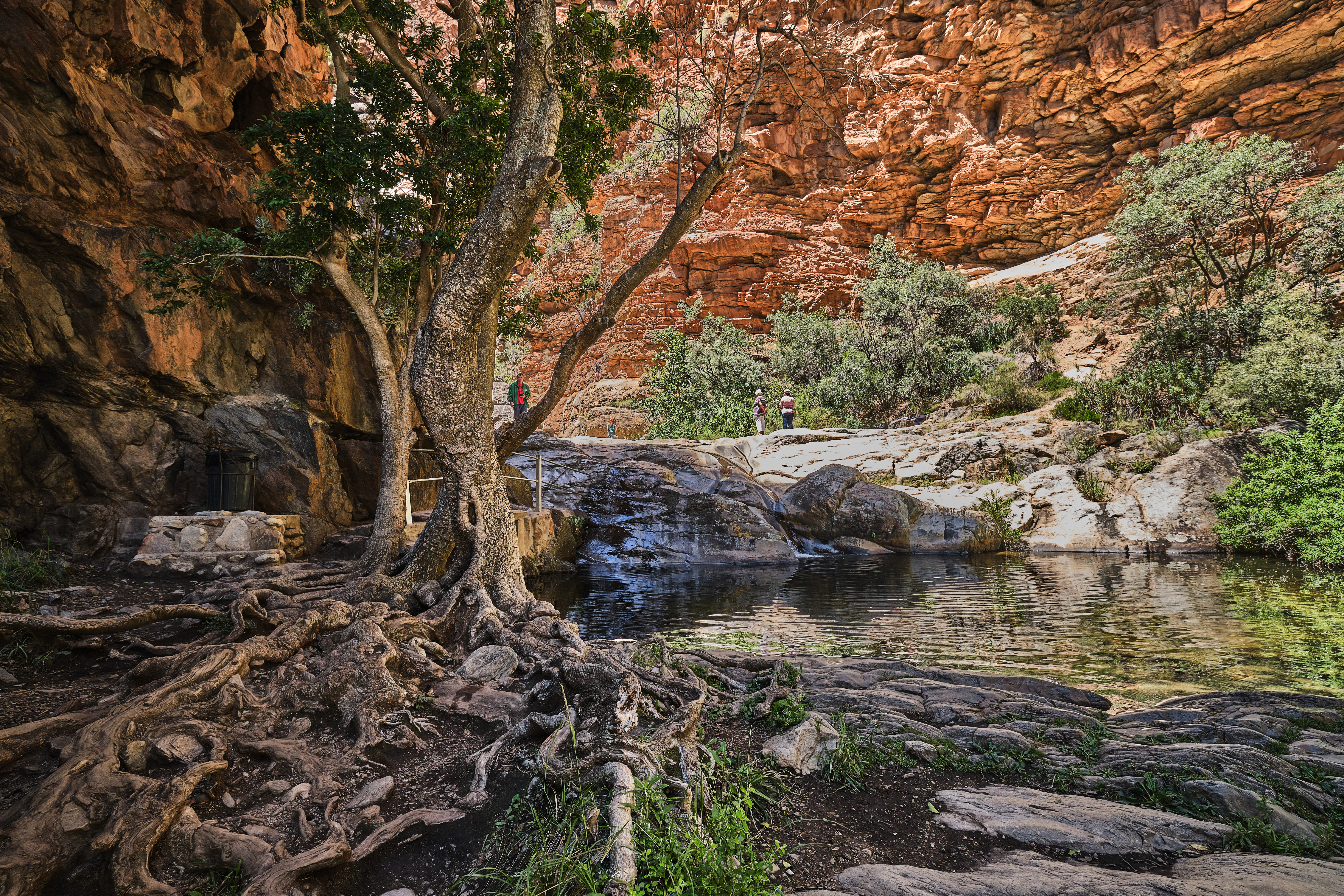 Natural rock pool beneath towering sandstone canyon walls in Meiringspoort in the Klein Karoo region of South Africa.