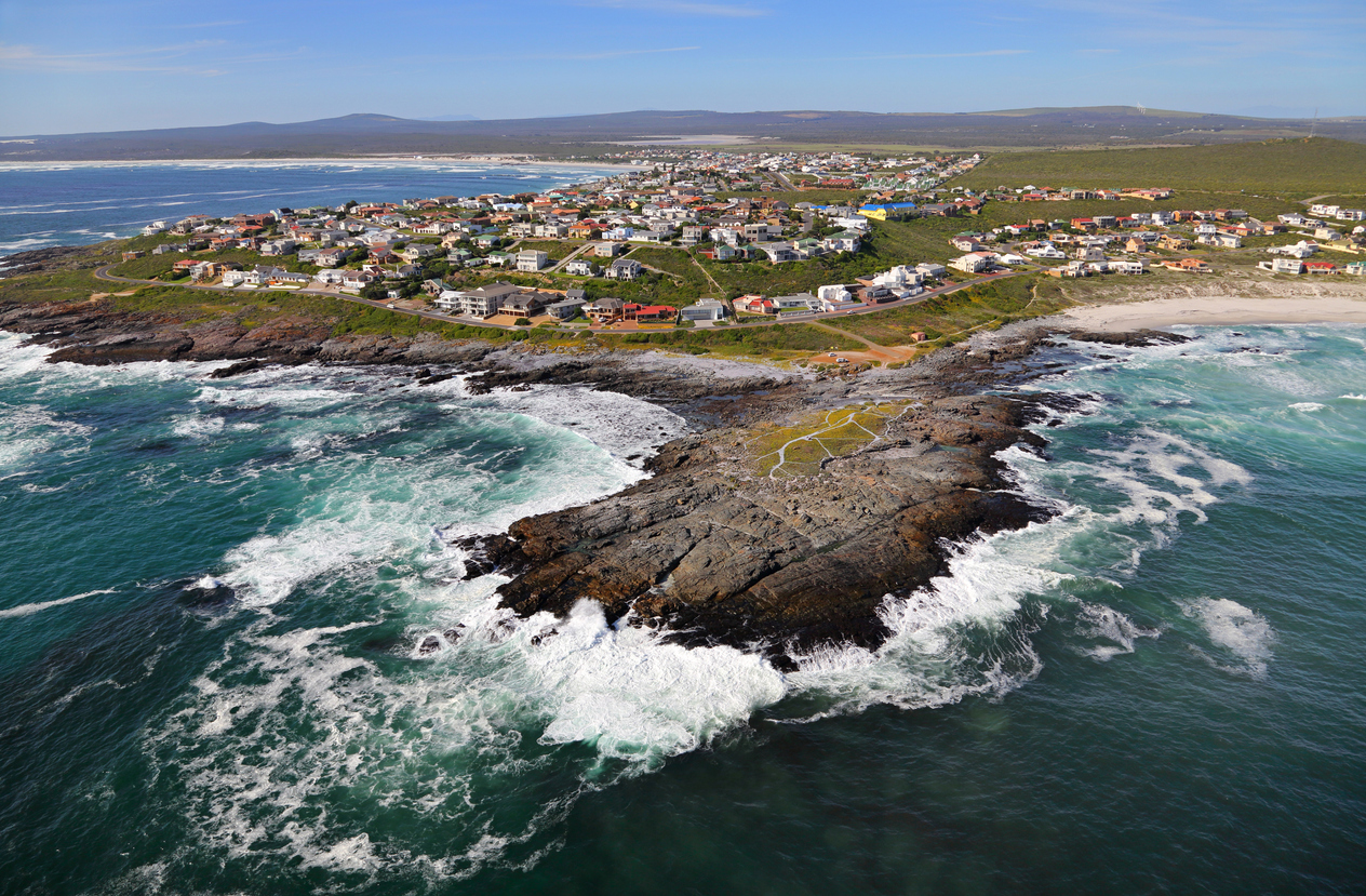 Drone view of Yzerfontein showing granite coastal headlands, sandy beaches, residential areas and the Atlantic coastline on South Africa's West Coast.
