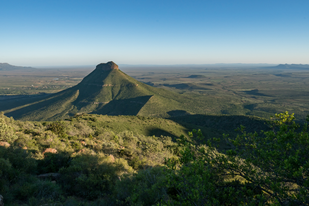 Conical mountain and expansive Karoo plains viewed from Camdeboo National Park near Graaff-Reinet in the Eastern Cape, South Africa.
