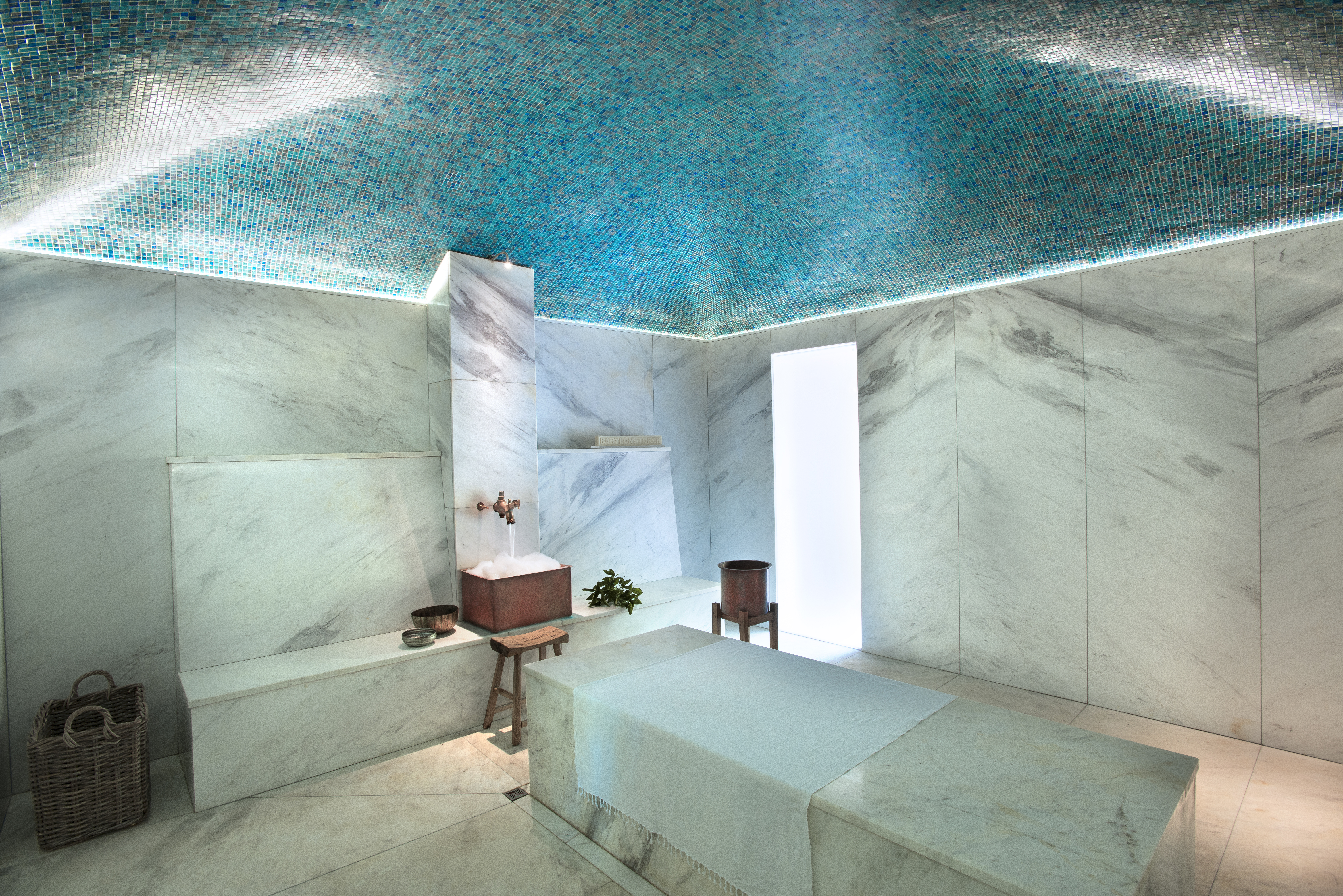 Luxury hammam spa room at Babylonstoren with marble walls, turquoise mosaic ceiling, stone treatment table, and minimalist wellness architecture in South Africa’s Cape Winelands.