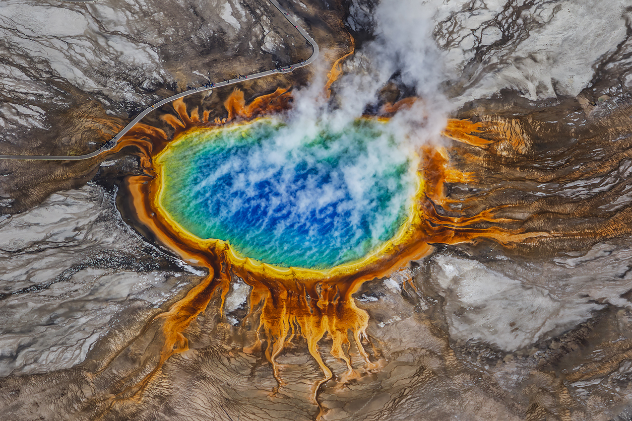 Grand Prismatic Spring Yellowstone aerial view showing colorful geothermal hot spring with steam and bacterial mats