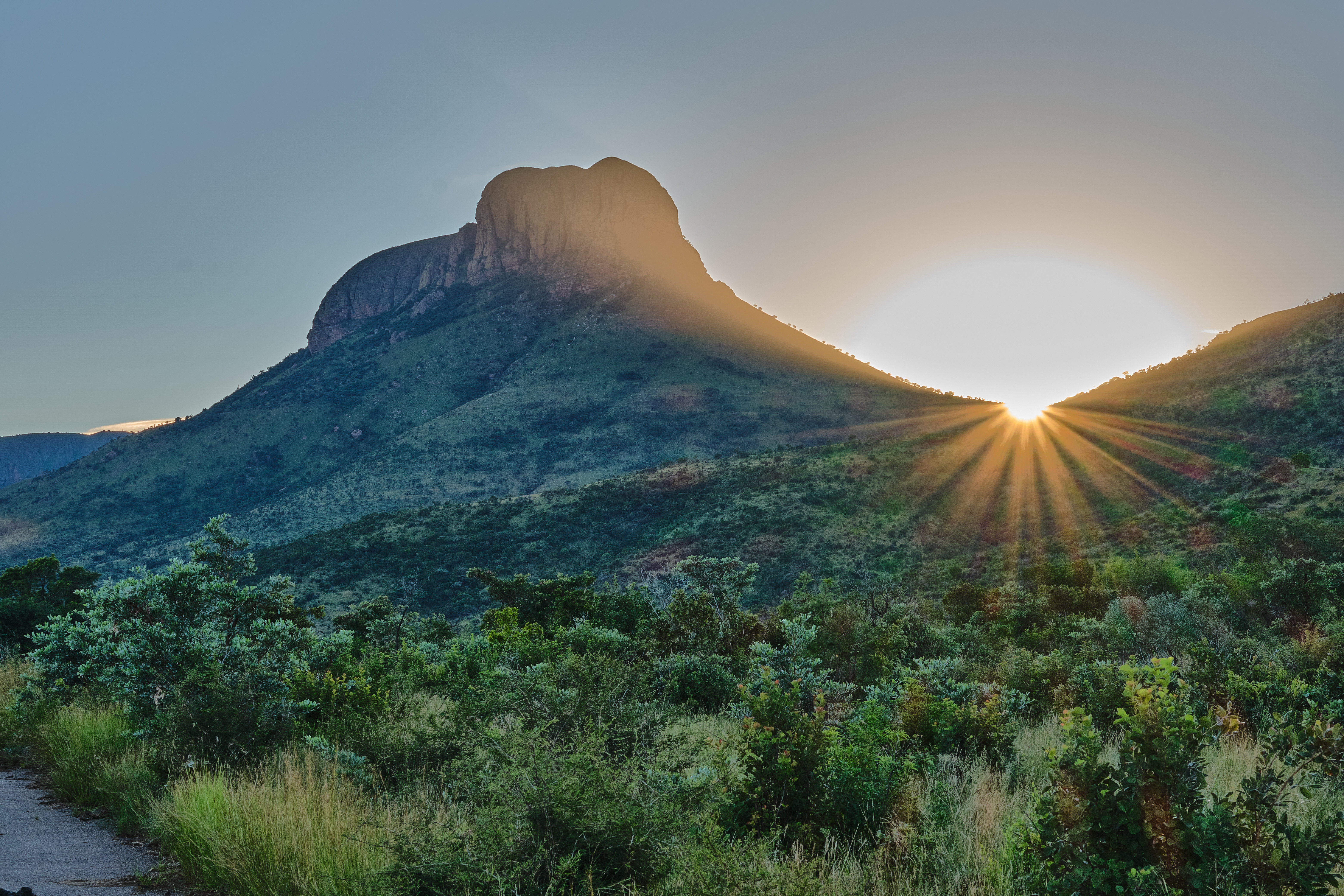 Sunrise behind a mountain peak in Marakele National Park, illuminating the Waterberg mountains and bushveld landscape of Limpopo, South Africa.