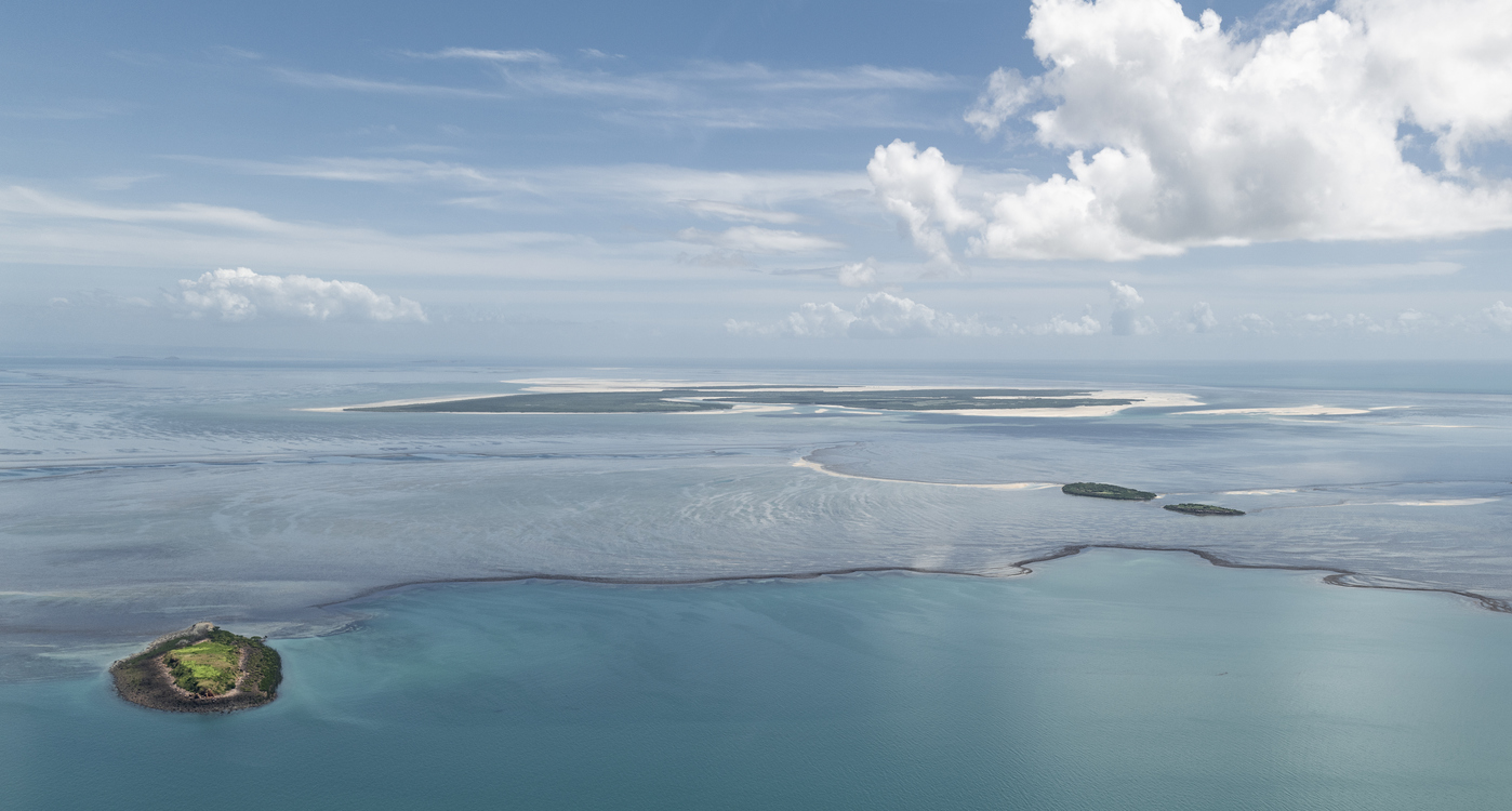 Aerial view across Montgomery Reef as exposed reef and tidal channels emerge from the turquoise waters of the Kimberley coast.
