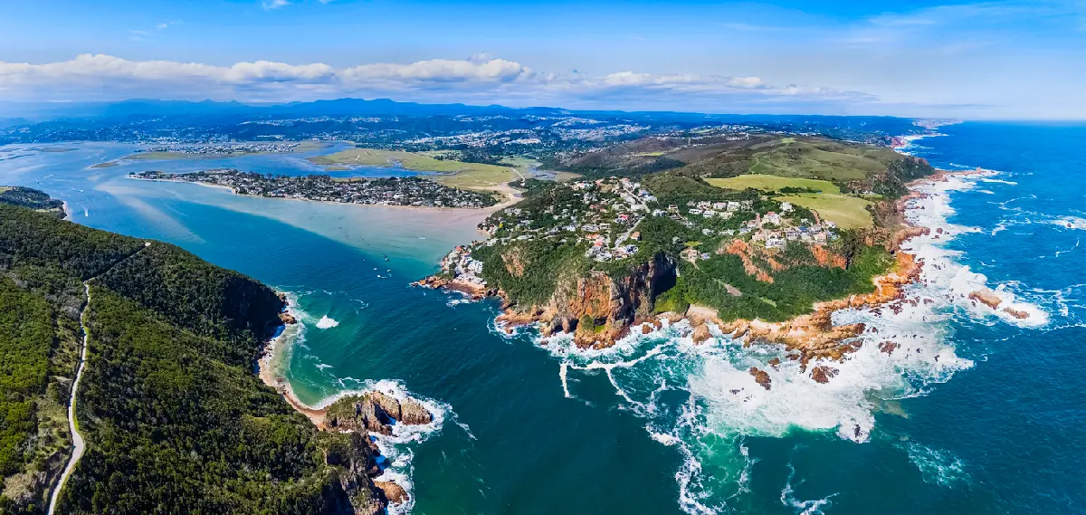 Aerial view of Knysna Heads showing the rocky headlands, ocean entrance and expansive Knysna Lagoon beyond on South Africa’s Garden Route.