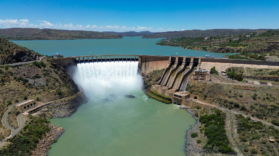 Aerial view of Gariep Dam with water flowing through the spillway into the Orange River, South Africa