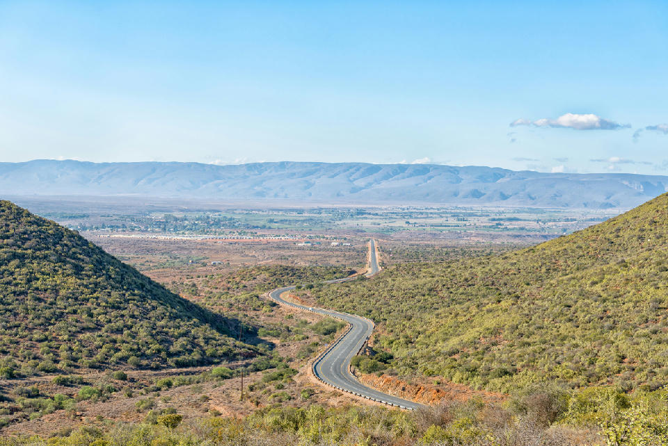 Winding road descending into the Klein Karoo landscape near Calitzdorp in the Western Cape, South Africa.