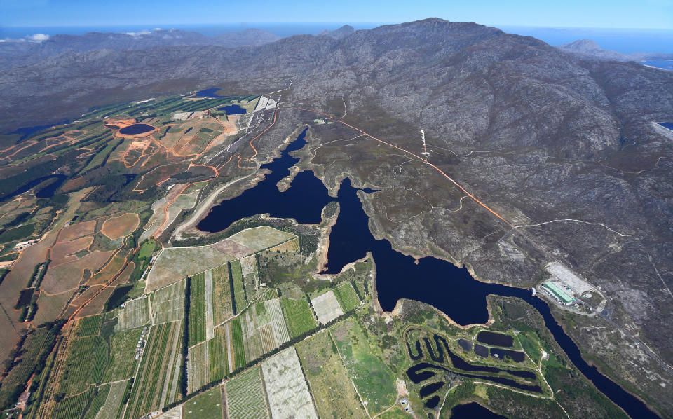 High aerial view of the Elgin Valley with orchards, reservoirs, farmland, and surrounding mountain ranges in the Western Cape, South Africa.