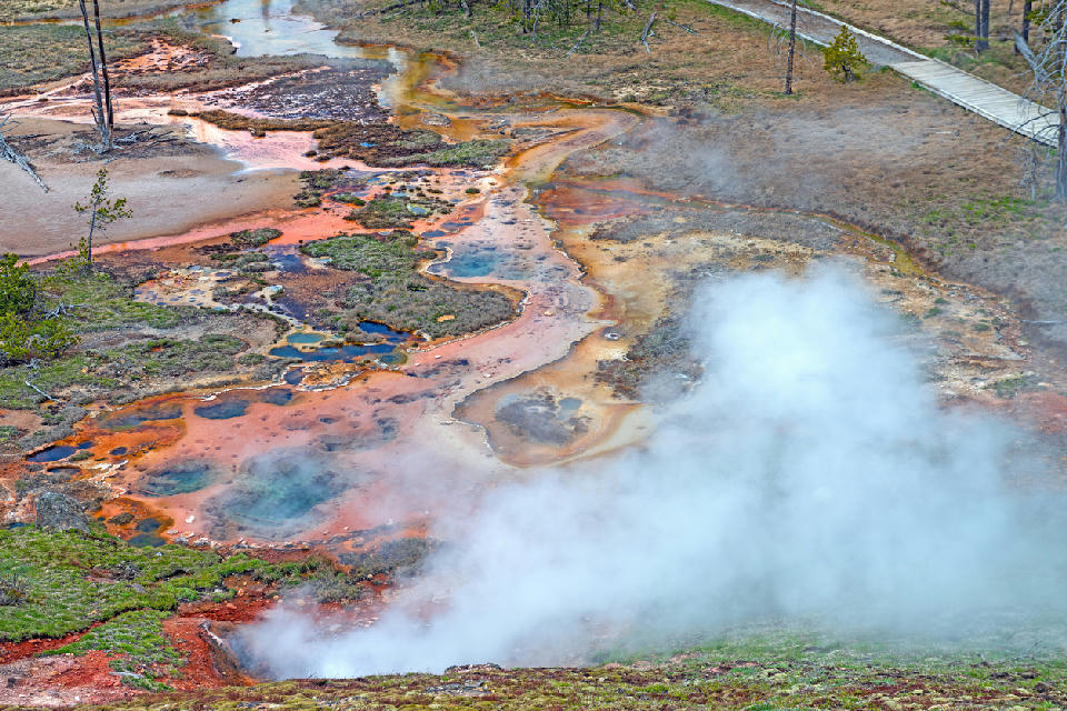Aerial view of multicolored hot springs, mineral deposits, and steam vents at Artists Paintpots in Yellowstone National Park, Wyoming.