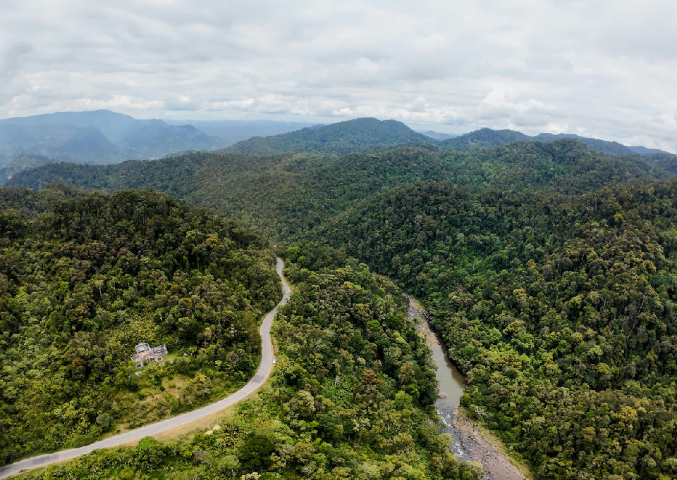 Aerial view of the Ranomafana rainforest landscape in Madagascar with dense jungle valleys, winding river, and layered tropical highlands