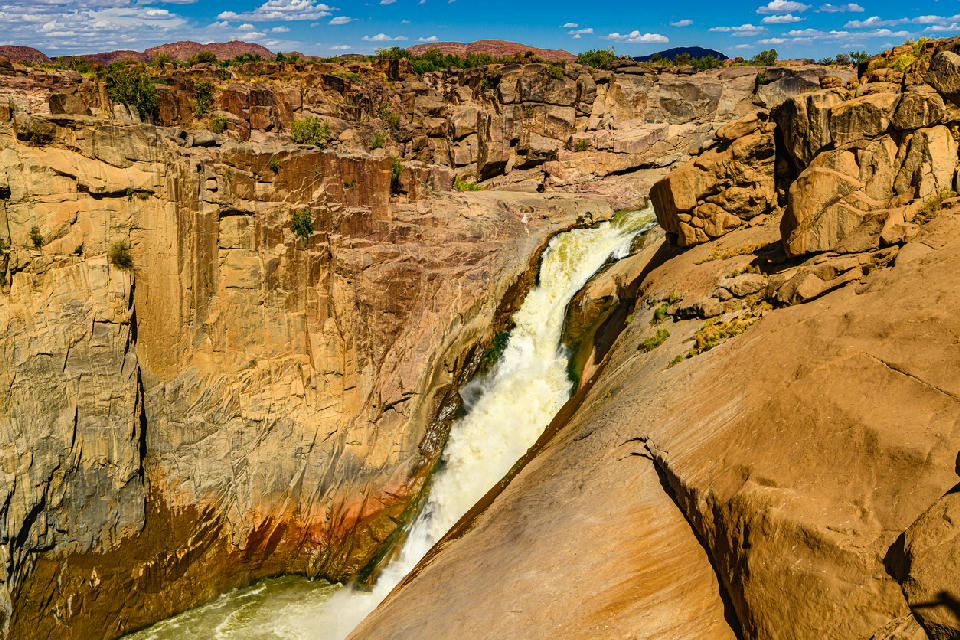 Augrabies Falls cascading into a deep rocky granite canyon in Augrabies Falls National Park, Northern Cape, South Africa.