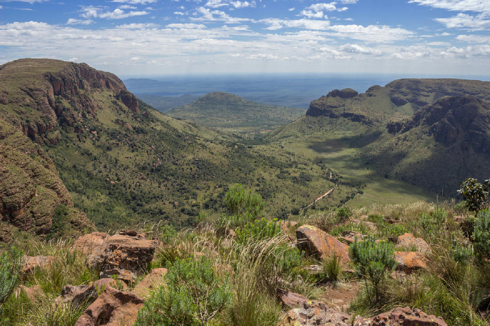 View across the Waterberg Biosphere showing sandstone cliffs, mountain valleys and bushveld landscapes in Limpopo, South Africa.