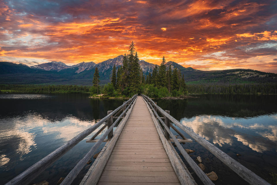 Wooden bridge leading to Pyramid Island at sunset with dramatic sky over Pyramid Lake