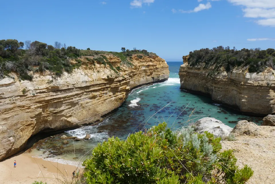 View across Loch Ard Gorge with limestone cliffs, turquoise water and beach in Victoria, Australia.