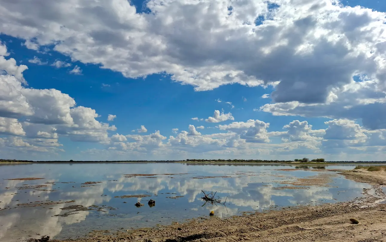 Storm clouds reflected in the shallow waters of Nxai Pan after the rainy season in Botswana.