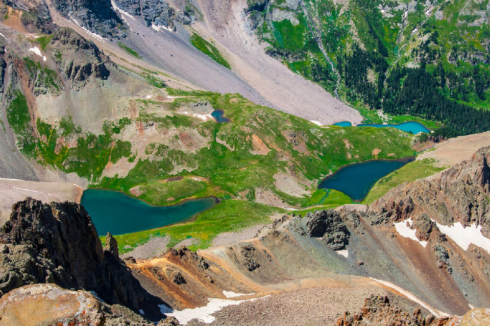 Aerial view of Blue Lakes below Mount Sneffels with turquoise alpine lakes and rugged mountain terrain, San Juan Mountains Colorado.