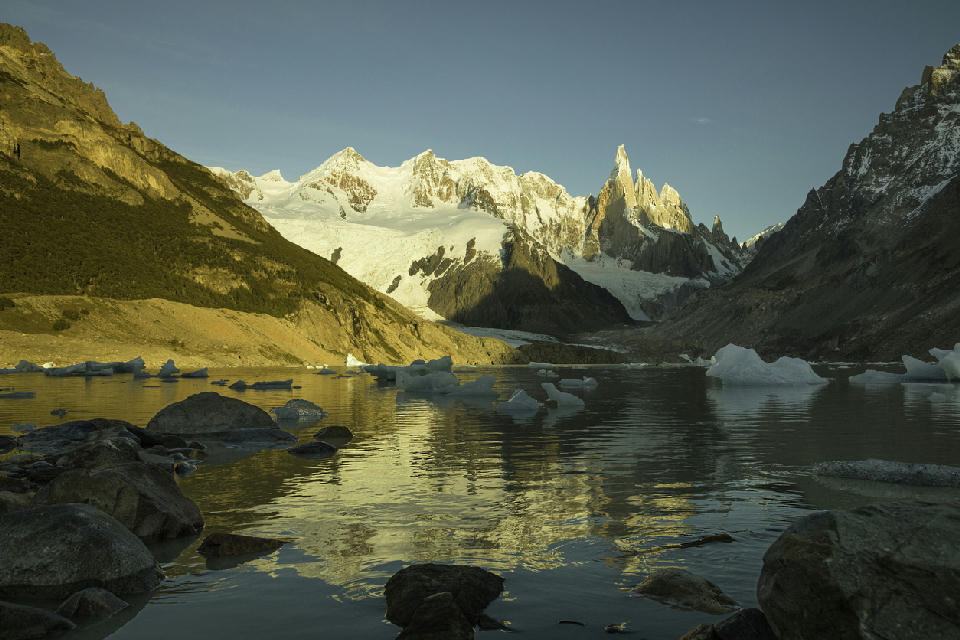 Sunrise at Laguna Torre with Cerro Torre and floating icebergs reflected in the lake, Patagonia, Argentina.
