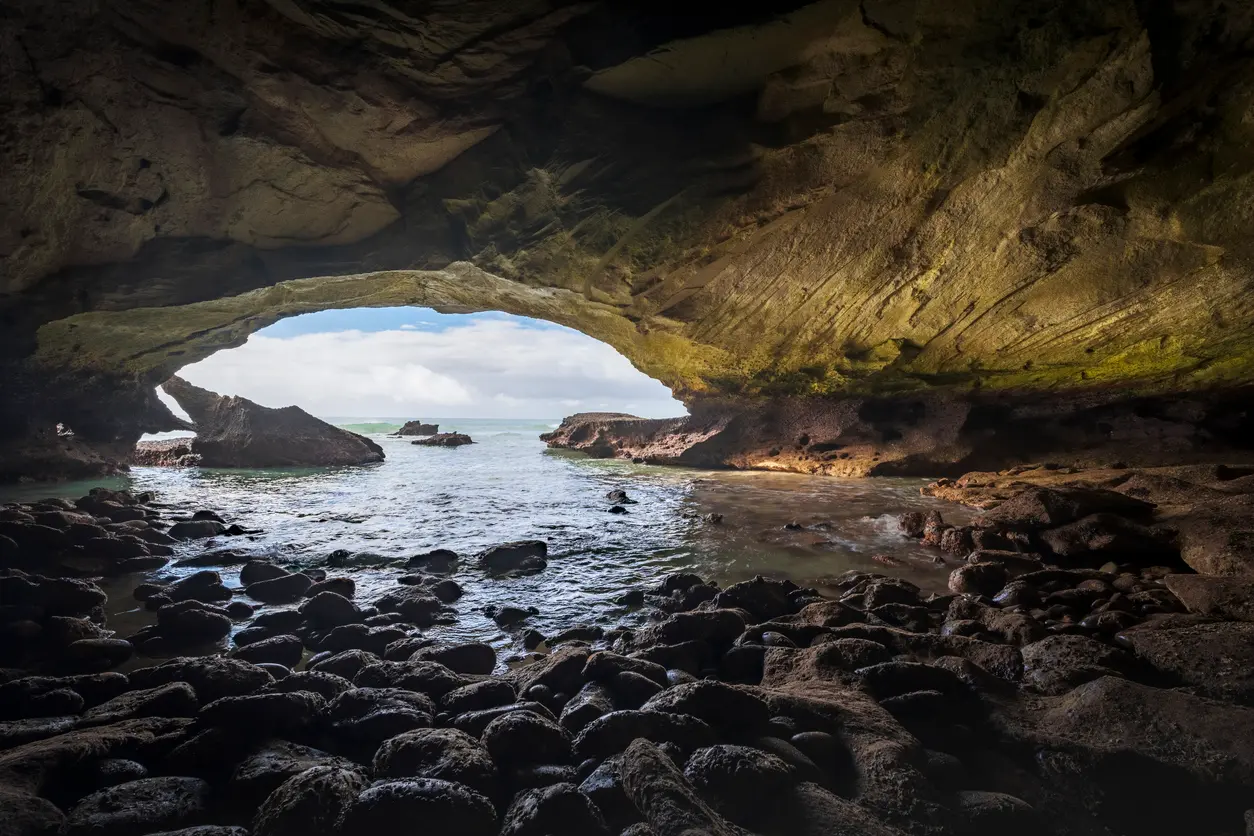 View from inside Waenhuiskrans Cave near Arniston looking through the large sea-cave opening toward the Indian Ocean, Western Cape, South Africa