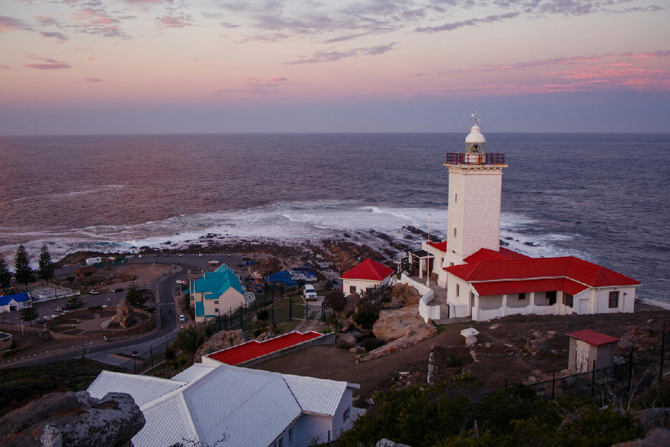 Cape St. Blaize Lighthouse overlooking the Indian Ocean at sunset in Mossel Bay, South Africa