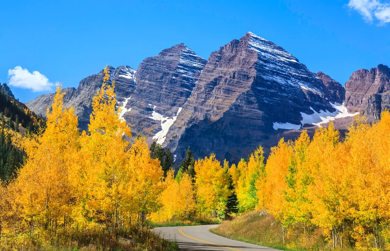 Maroon Bells with autumn aspens and road Aspen Colorado