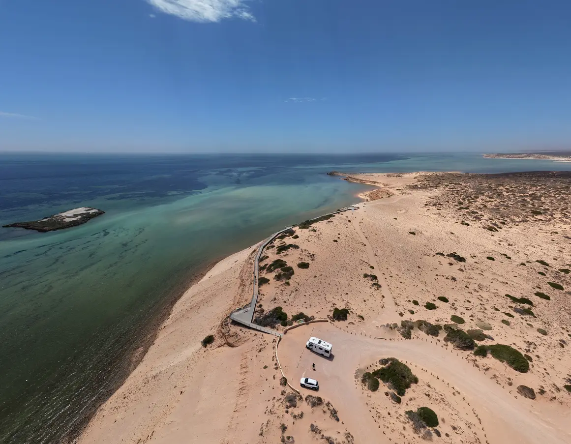 Aerial view of Eagle Bluff Lookout, its clifftop boardwalk and sweeping turquoise waters of Henri Freycinet Harbour.
