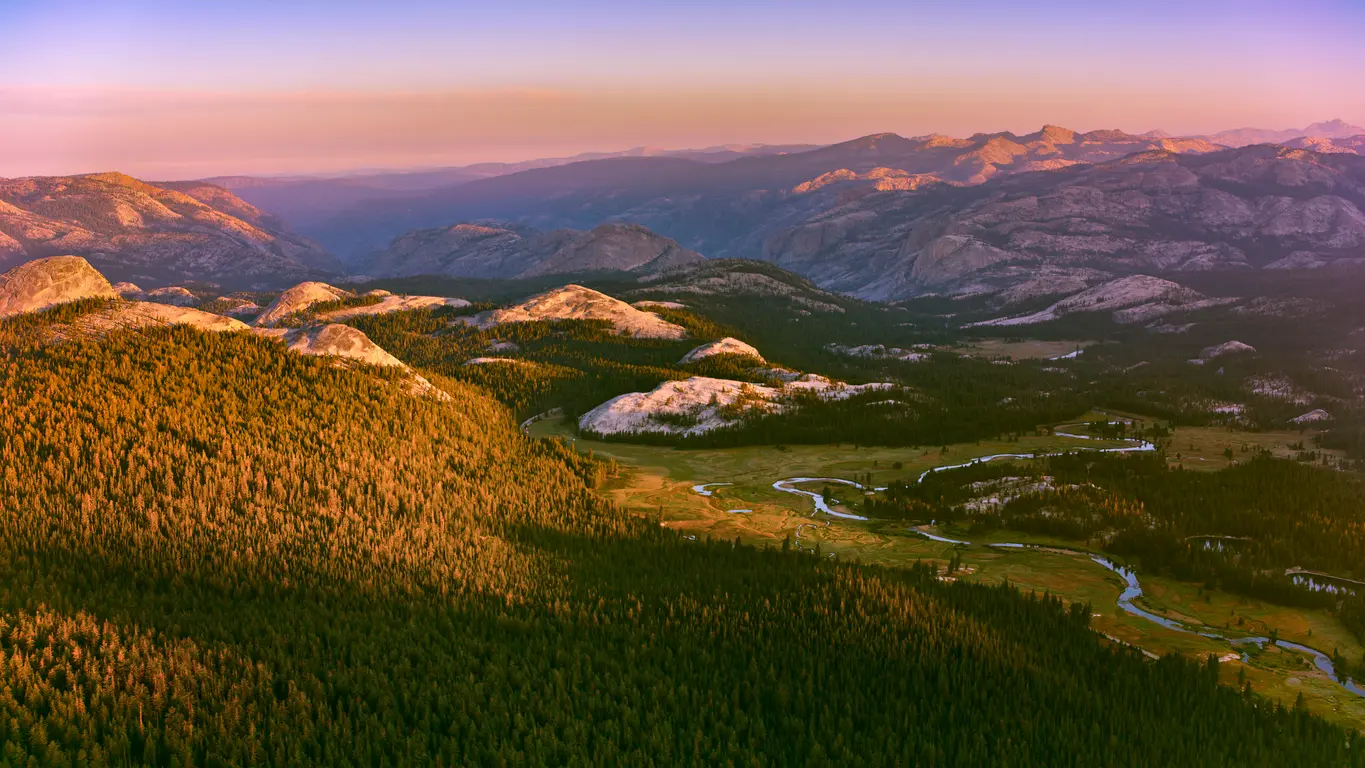 Tuolumne River winding through Tuolumne Meadows at sunset in Yosemite National Park, California.