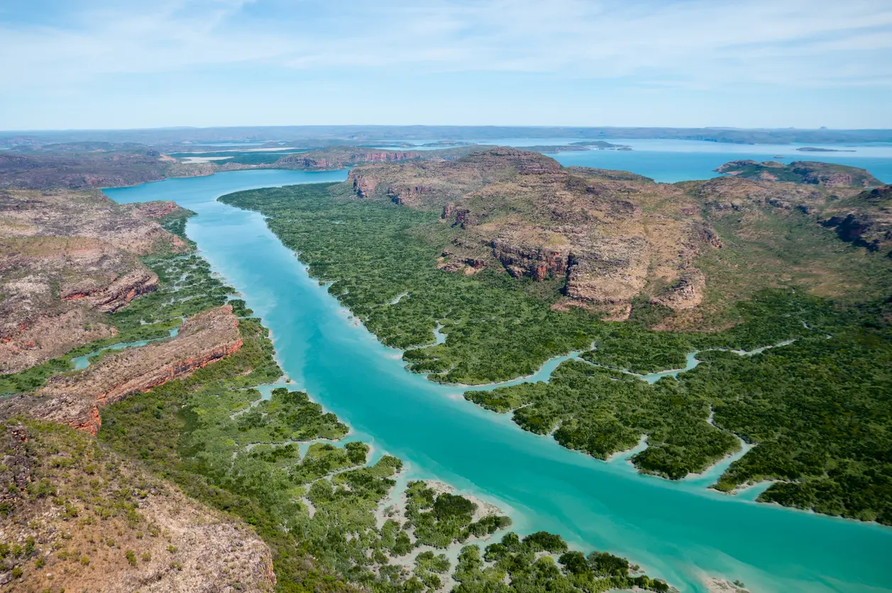 Turquoise waters of Porosus Creek wind through dense mangroves and rugged sandstone country in Prince Frederick Harbour.