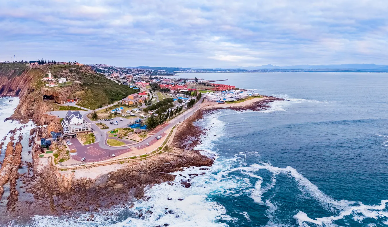 Aerial view of The Point headland and Cape St Blaize Lighthouse overlooking the rocky coastline of Mossel Bay, South Africa.