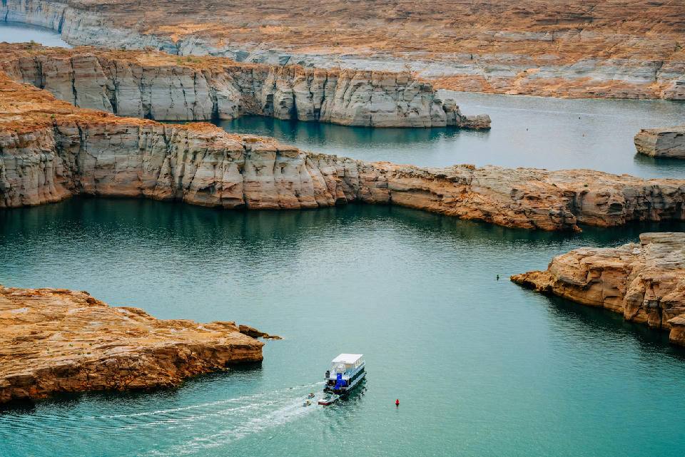 Lake Powell houseboat sandstone canyon channels Glen Canyon Utah Arizona shoreline