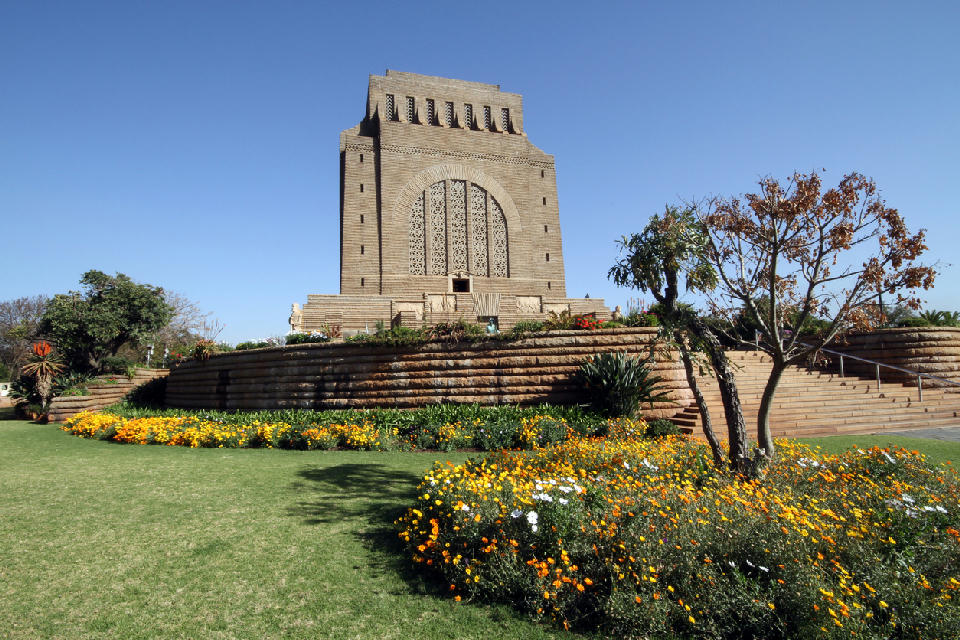 Voortrekker Monument rising above formal gardens and flower beds in Pretoria, Gauteng.