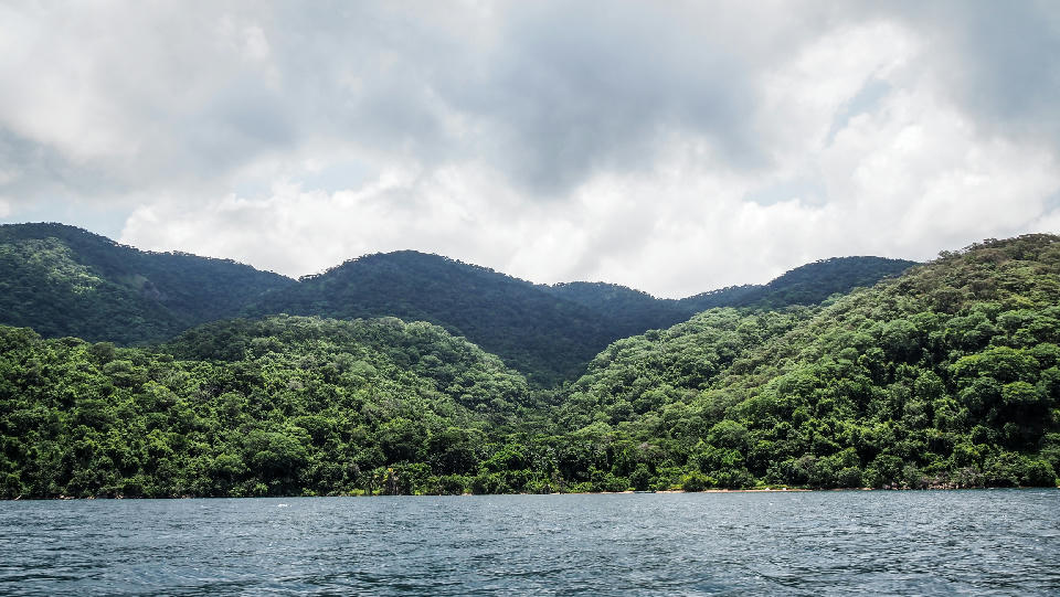 Rainforest-covered mountains of Mahale Mountains National Park rising above Lake Tanganyika in western Tanzania.