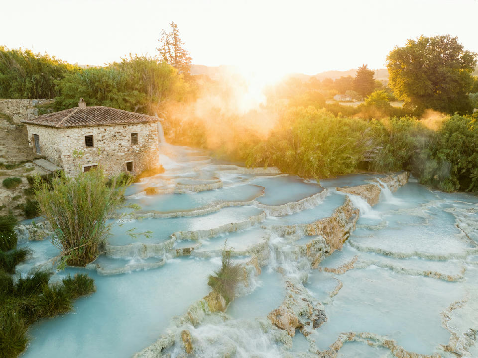 Aerial view of Cascate del Mulino, showing terraced thermal pools near Manciano in southern Tuscany, Italy.