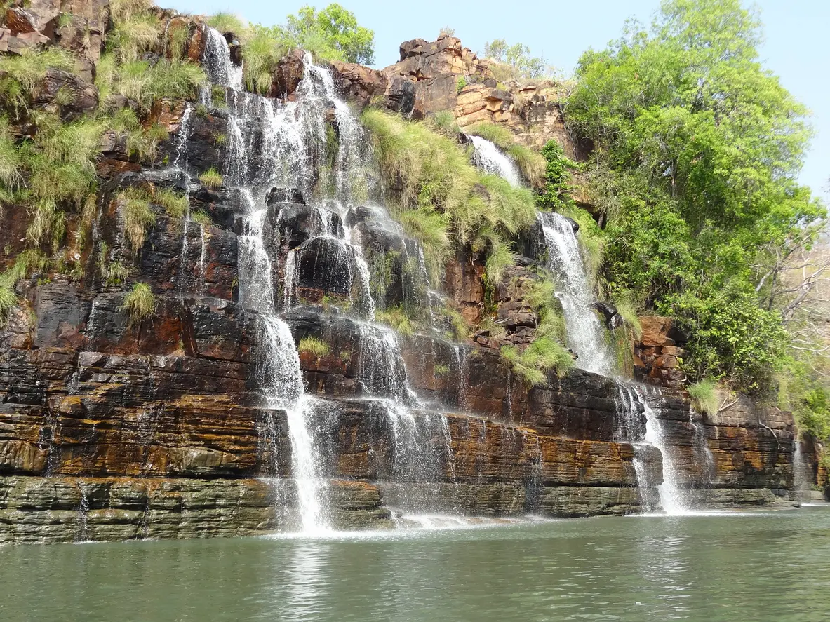Water cascades over the terraced rock face of Kings Cascade into the Prince Regent River.