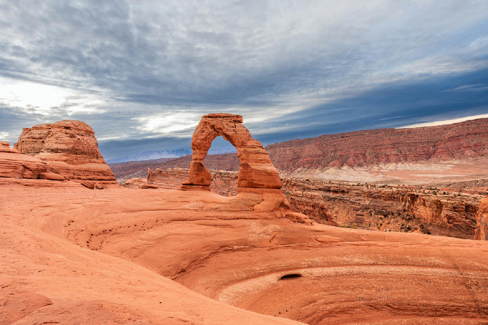 Delicate Arch viewed from the main viewpoint with slickrock foreground in Arches National Park Utah
