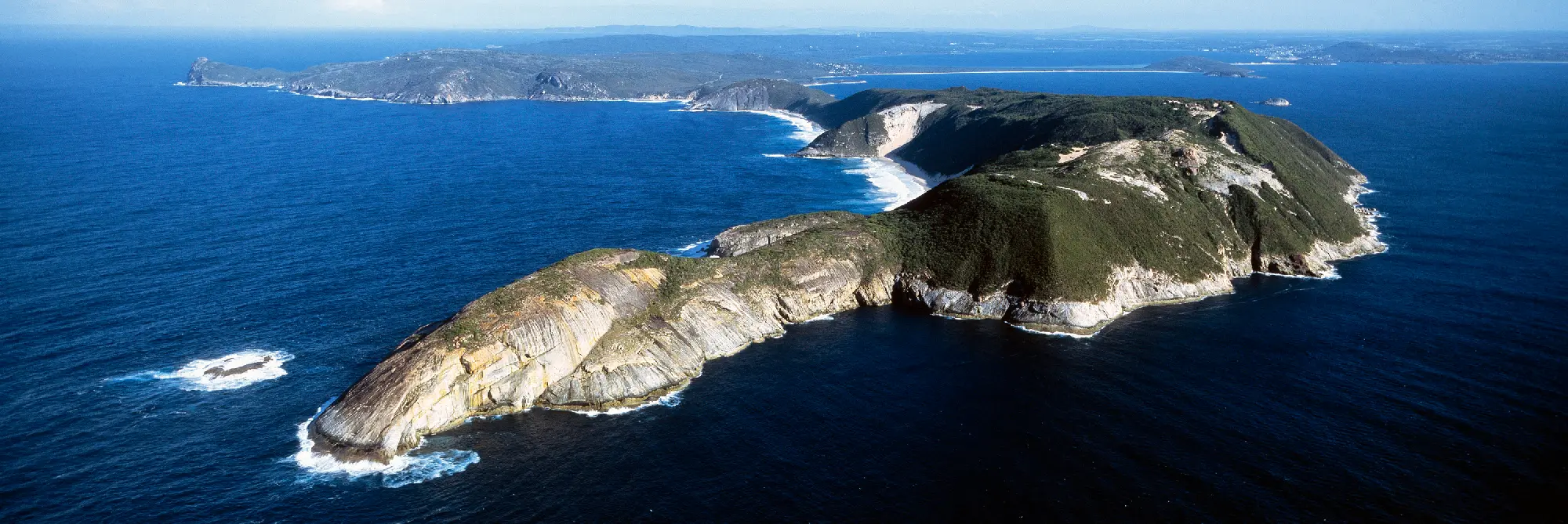 Aerial view of Bald Head, rugged coastal headlands and beaches surrounded by the Southern Ocean near Albany, Western Australia.