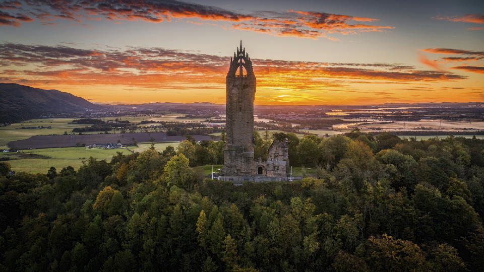 The Wallace Monument tower on Abbey Craig overlooking the landscape near Stirling in Central Scotland.