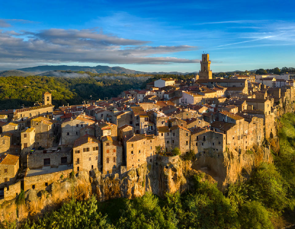 Aerial view of the medieval hilltop town of Pitigliano perched on volcanic cliffs in the Maremma region of Tuscany, Italy.