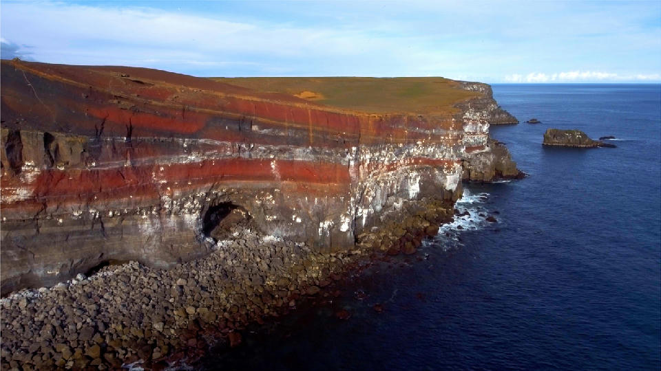 Layered coastal cliffs of Rauðaskriða at Krýsuvíkurberg on the Reykjanes Peninsula, Iceland, overlooking the North Atlantic Ocean.