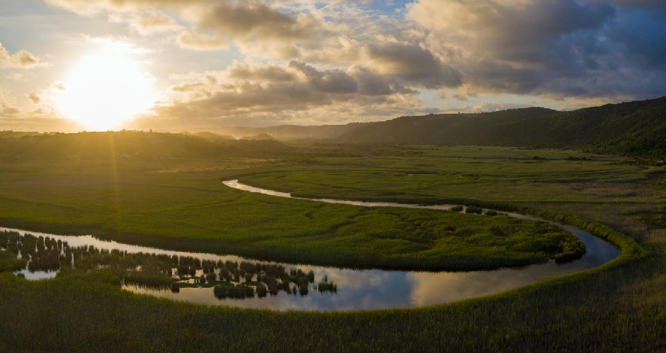 Aerial sunset view of the Serpentine River winding through the wetlands of Wilderness on South Africa's Garden Route.