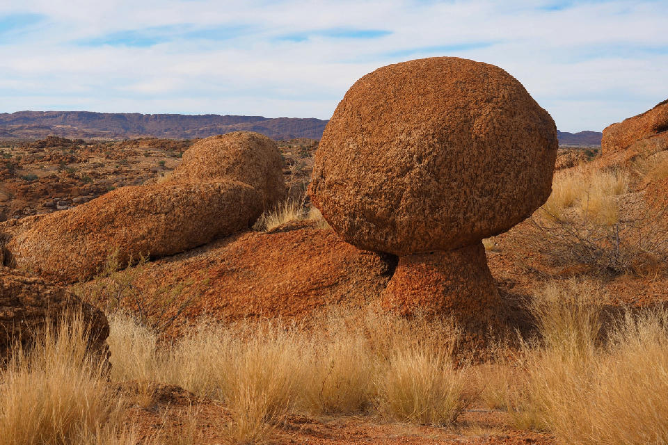 Balancing granite boulder perched on weathered rock at Moon Rock in Augrabies Falls National Park, Northern Cape, South Africa.