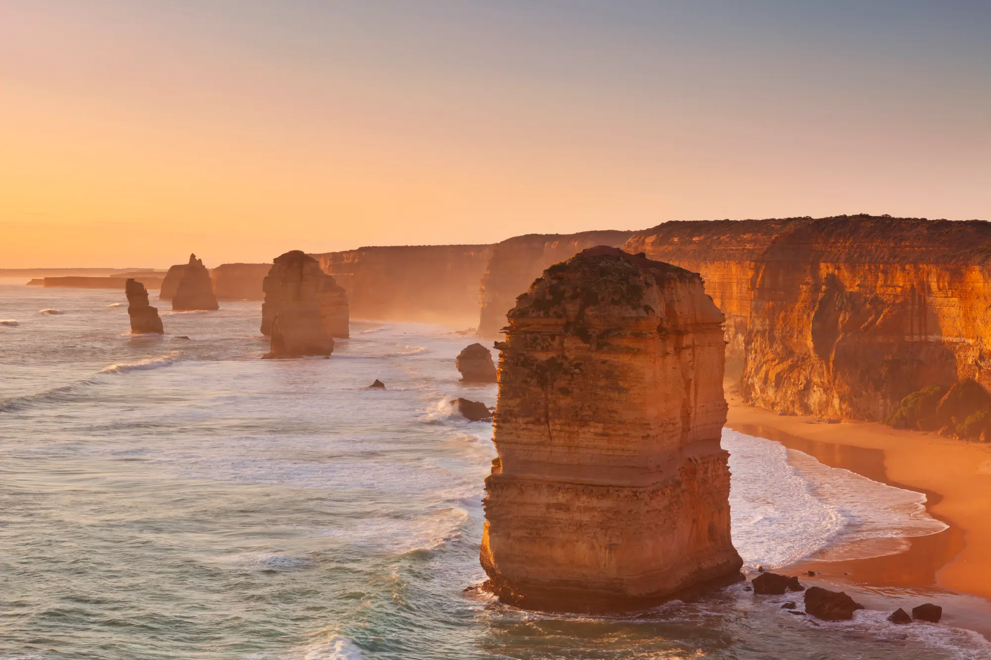 Twelve Apostles limestone sea stacks at sunset on the Great Ocean Road, Victoria, Australia.