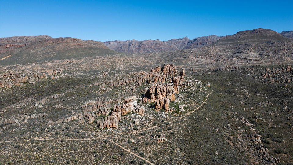 Aerial landscape of rugged sandstone rock formations, mountain ridges, and remote wilderness terrain in the Central Cederberg region of South Africa.