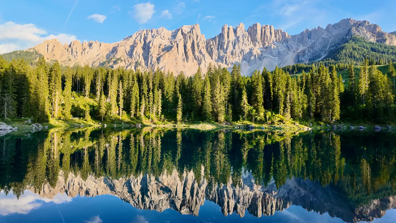 Lago di Carezza lake reflecting the Latemar mountains in the Dolomites, Italy.