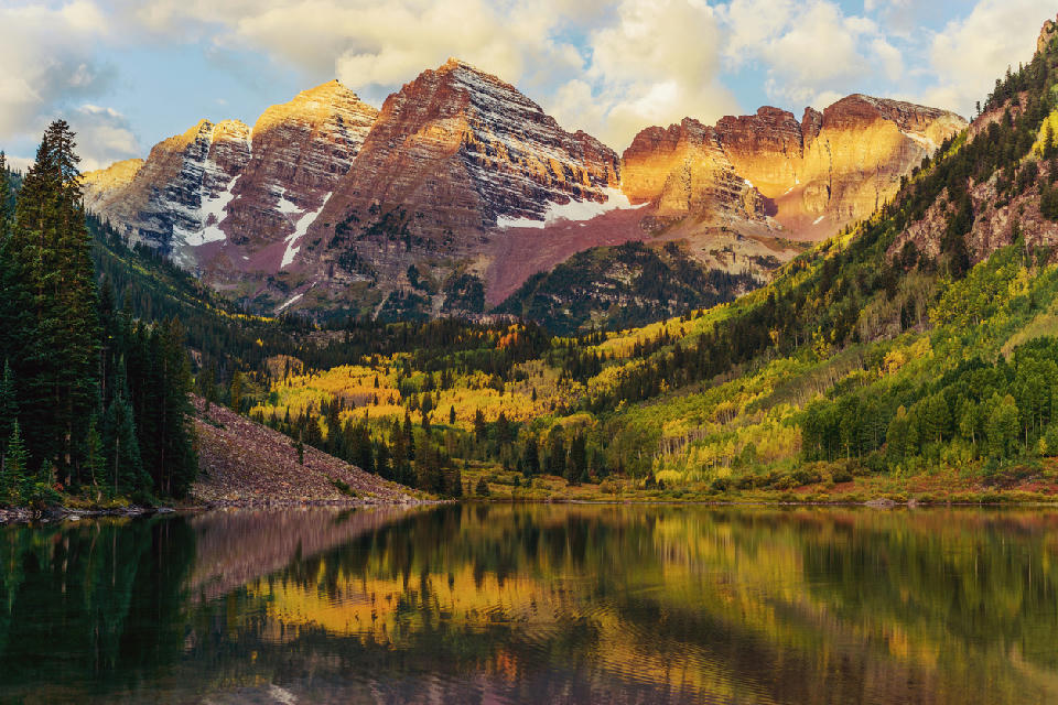 Maroon Bells reflection in Maroon Lake at sunrise with fall colors in Aspen Colorado
