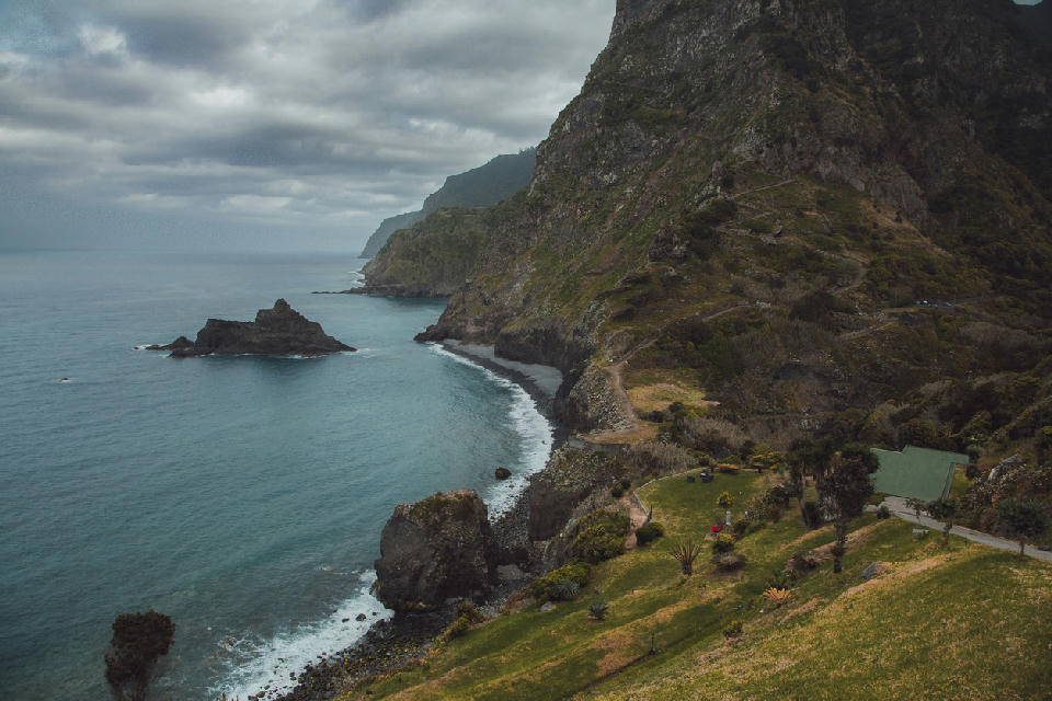 Volcanic cliffs and Atlantic coastline seen from Miradouro de São Cristóvão on Madeira Island, Portugal.
